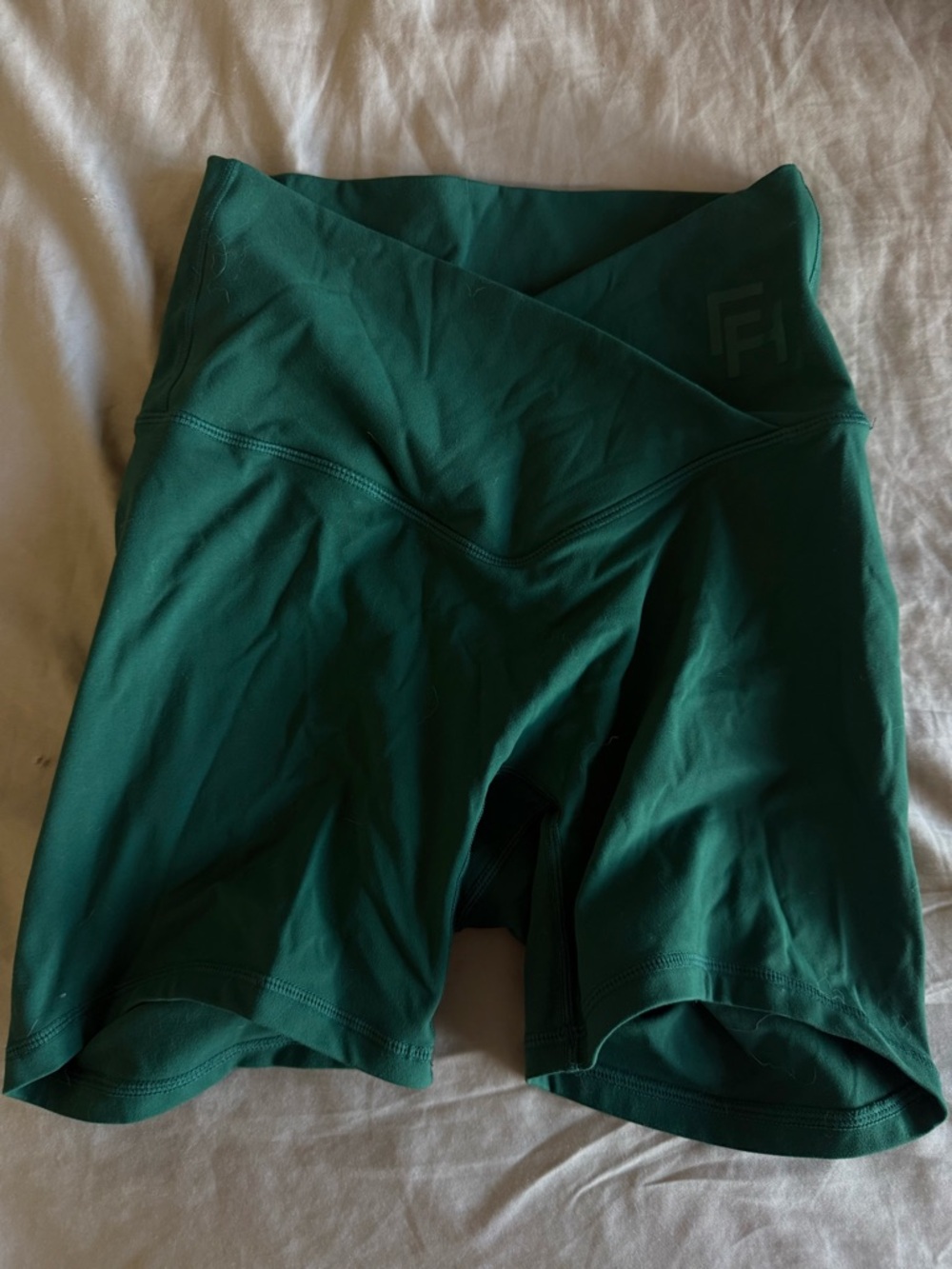 Deep green high-waisted wrap shorts